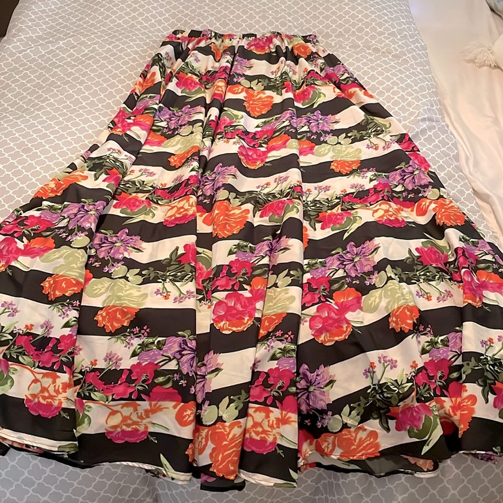 Beautiful floral print against black and white stripes flowing maxi skirt.